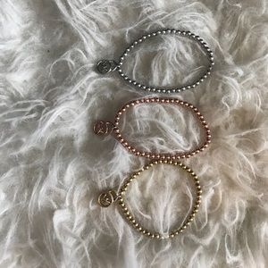 3 Michael Kors stretch brackets.
