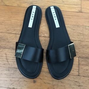 Zara black with gold buckle slide sandals.