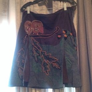 Skirt with embroidered owls and flounce inset.