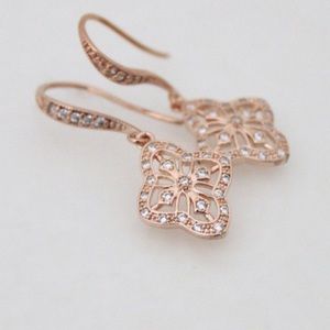 Rose gold dangle earrings.