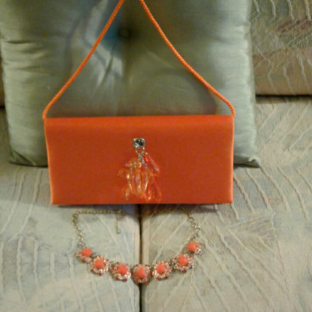 Lovely orange colored small vintage purse by Kate