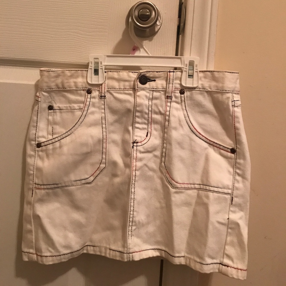 White skirt with red and blue stitching.