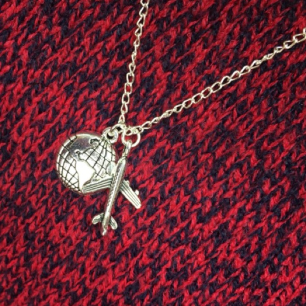 Silver airplane and globe necklace