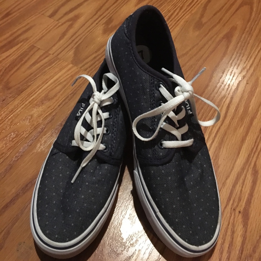 Women's Fila navy blue polka dot shoes.