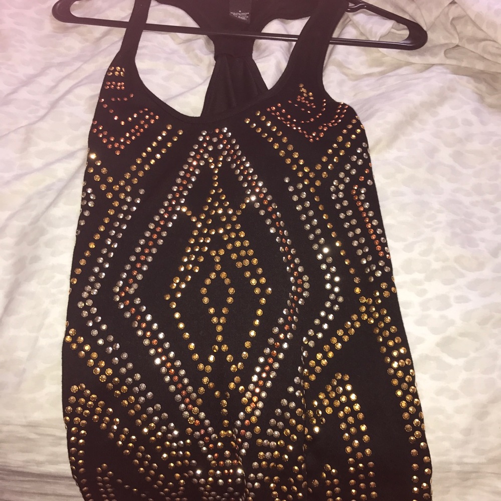 Black tank top with little jewelry on it