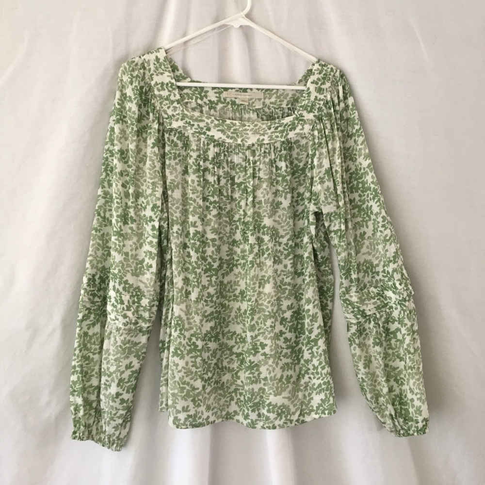 Lauren Conrad. Green blouse/off-white background.