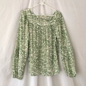 Lauren Conrad. Green blouse/off-white background.