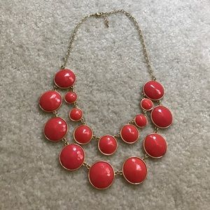 Red with a hint or orange/pink gold necklace