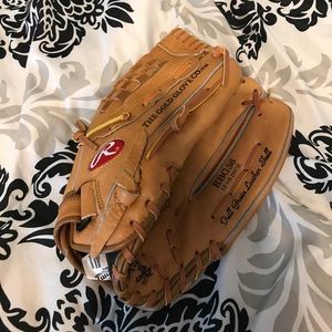 Rawlings softball glove with glove oil spray.