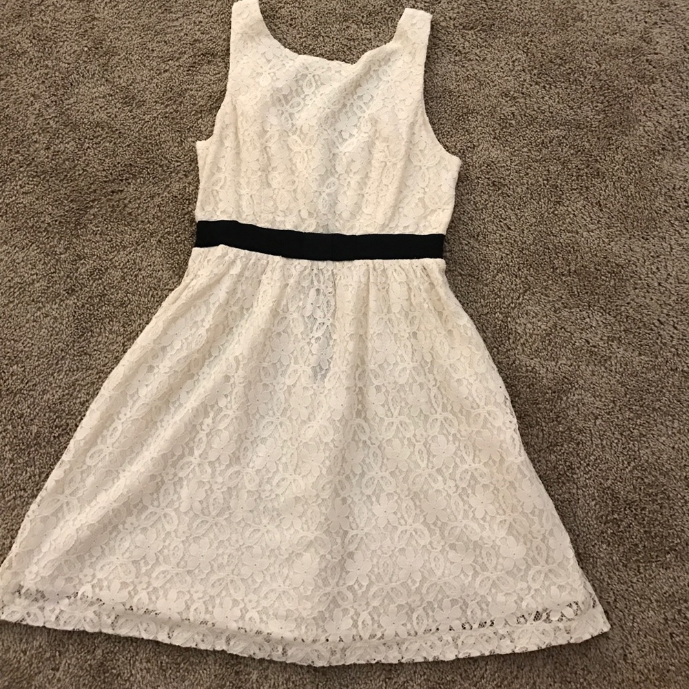 Lacy white dress with black strip around waist.
