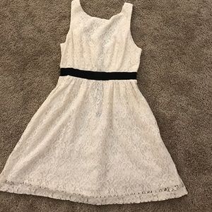 Lacy white dress with black strip around waist.
