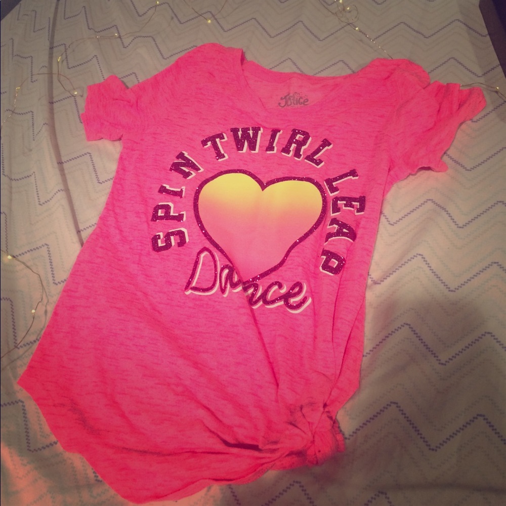I am selling a bright pink dance shirt.