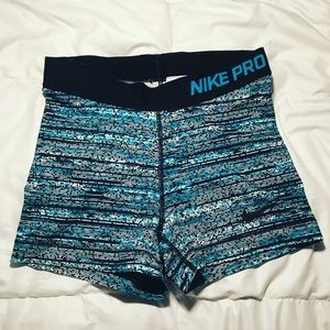 Teal/blue/black patterned Nike pro