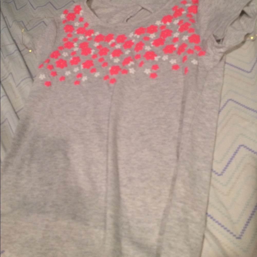 This is a gray blouse with flowers in the front.