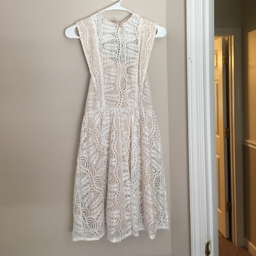 Elegant, white, lace dress with beige under layer