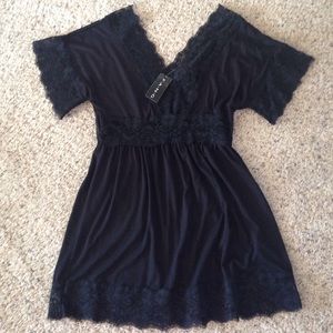 V neck poly, rayon, spandex low hip top.