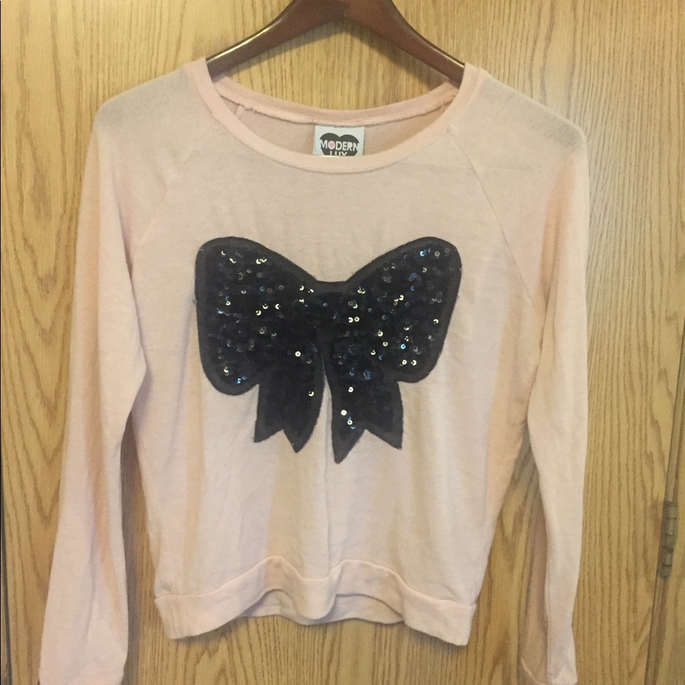 Light pink sweater with a sequined bow.