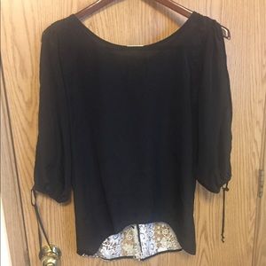 Black shirt with white lace back.