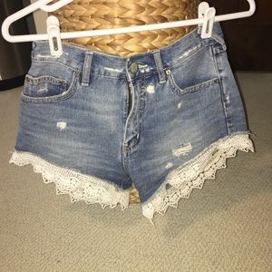 Free People jean shorts with lace trim