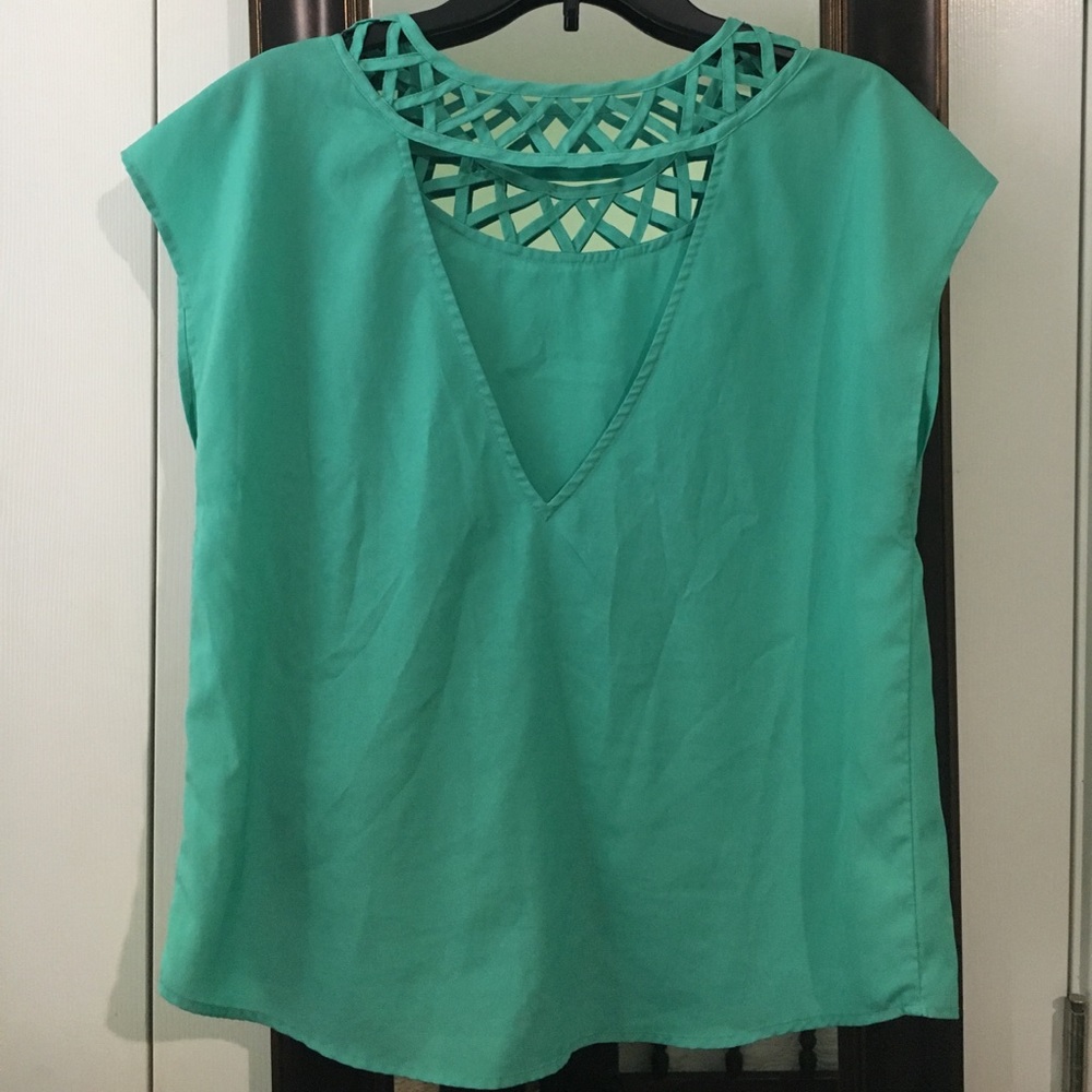 Sea green sleeveless blouse.