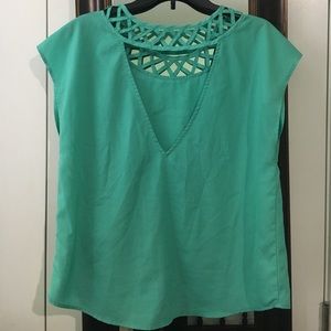 Sea green sleeveless blouse.