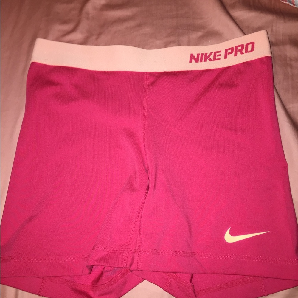 Reddish orange Nike pros