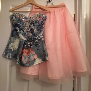 Embroidered strapless top and pink skirt.