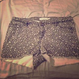 Faded black cut off jean shorts: lucky #13 print.
