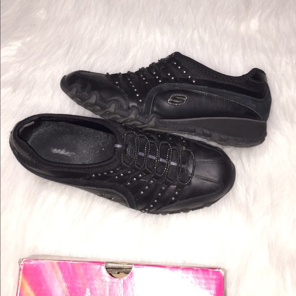 Skechers black slip on shoes with stud details