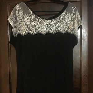 Black slinky blouse with white laced top portion