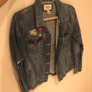 Distressed denim jacket with beauty pins