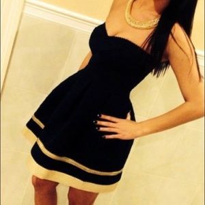 Black San Souci dress with gold trim on bottom