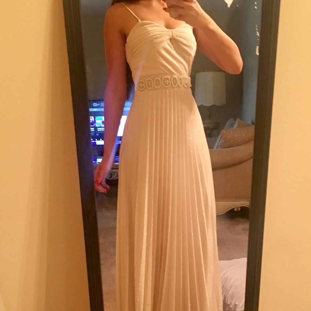 Cream colored long princess dress.