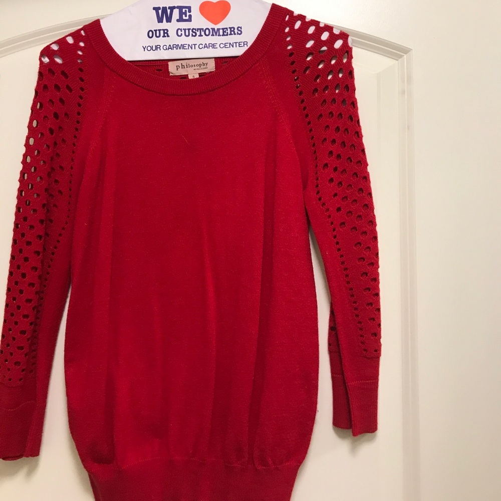 Sweater with accent holes on sleeves and back