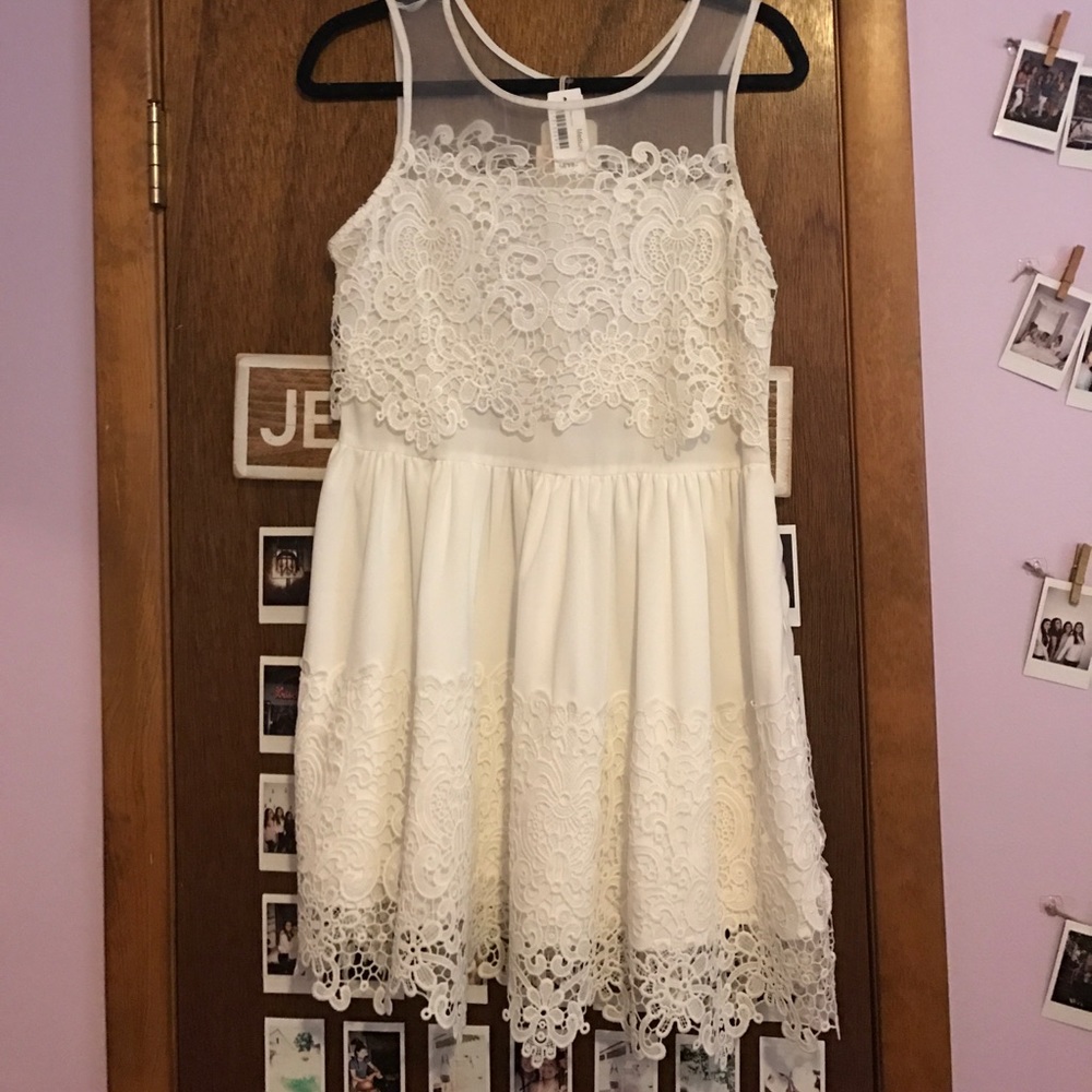 Elegant white lace dress with sheer neckline