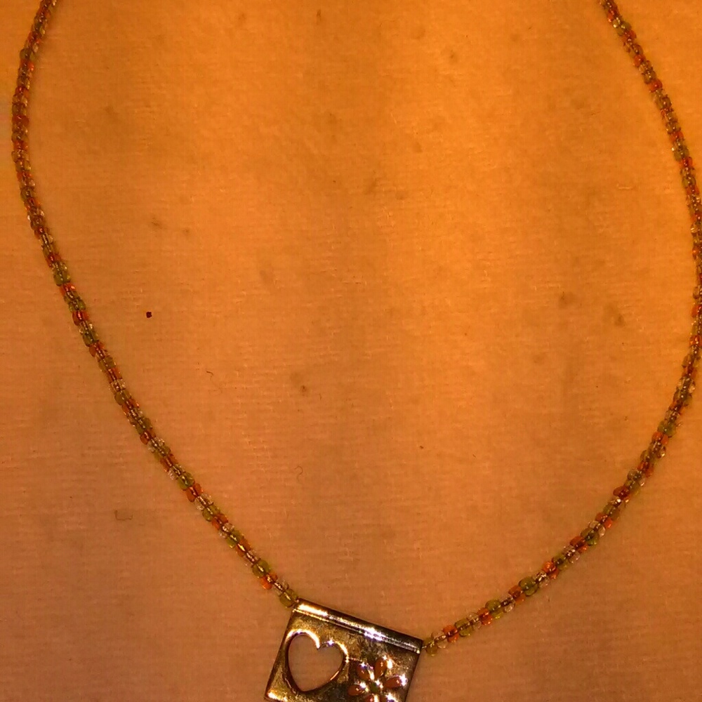 Beaded necklace with solver cutout heart