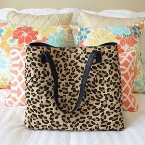 Reversible faux leather tote with wristlet.