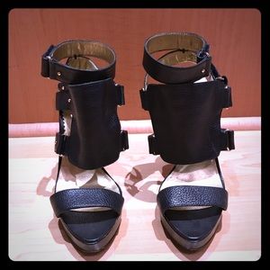 Report Strap heels in black