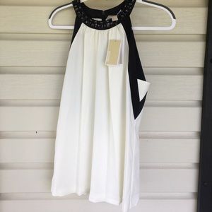 Flowy top with jewel neck accent. Never been worn