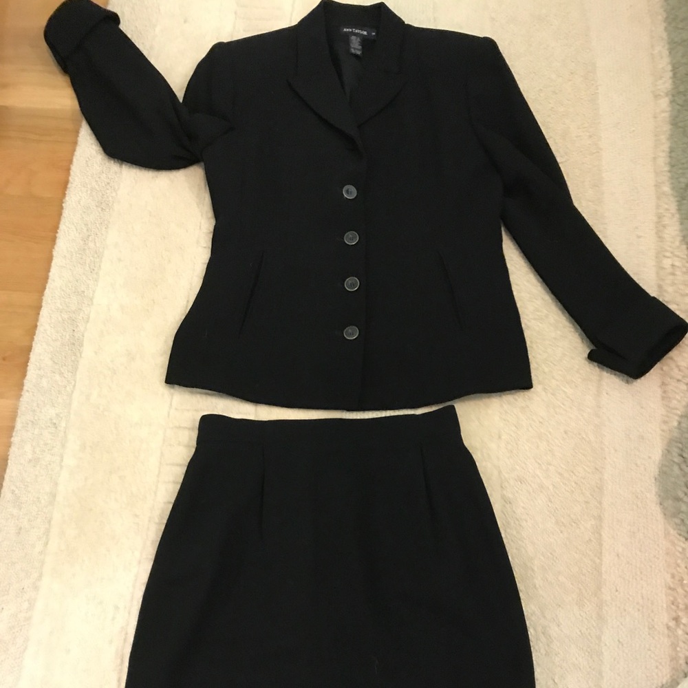 Black wool suit. Short skirt; cuff on sleeves
