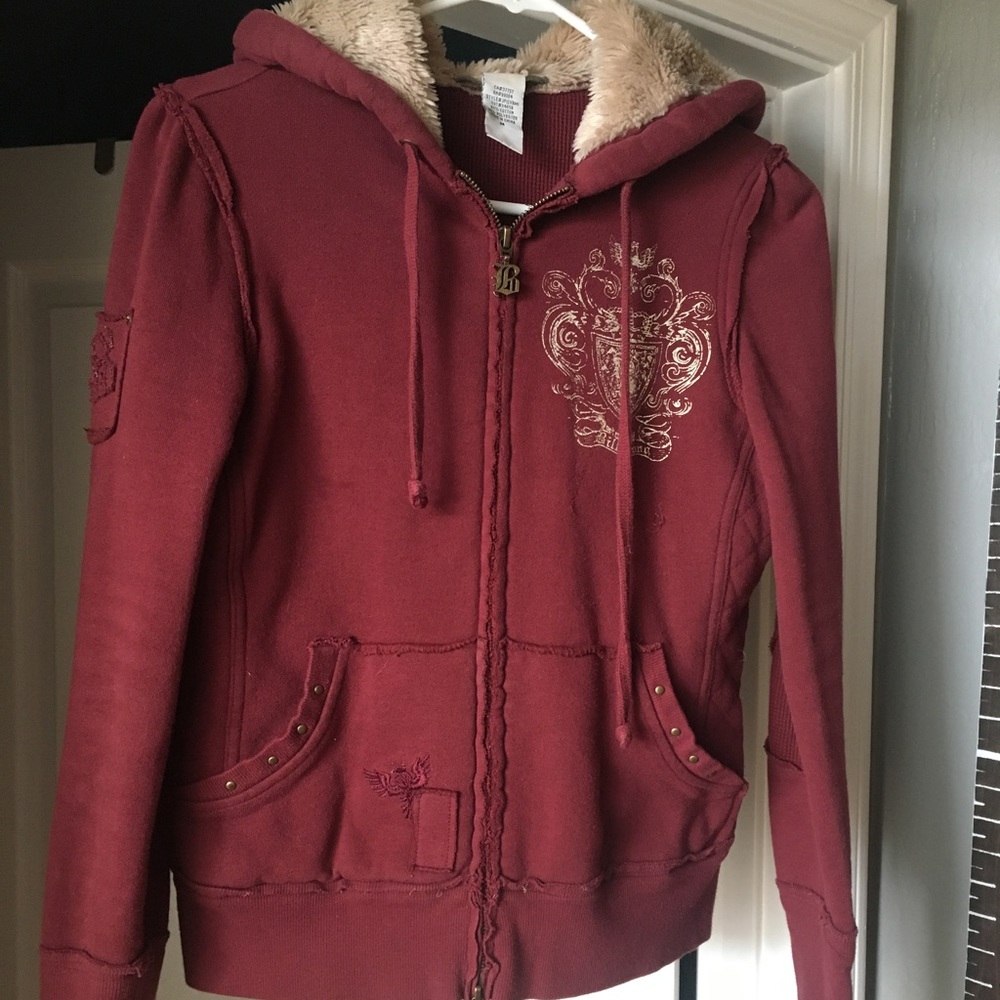 Maroon billabong zip up hooded jacket.