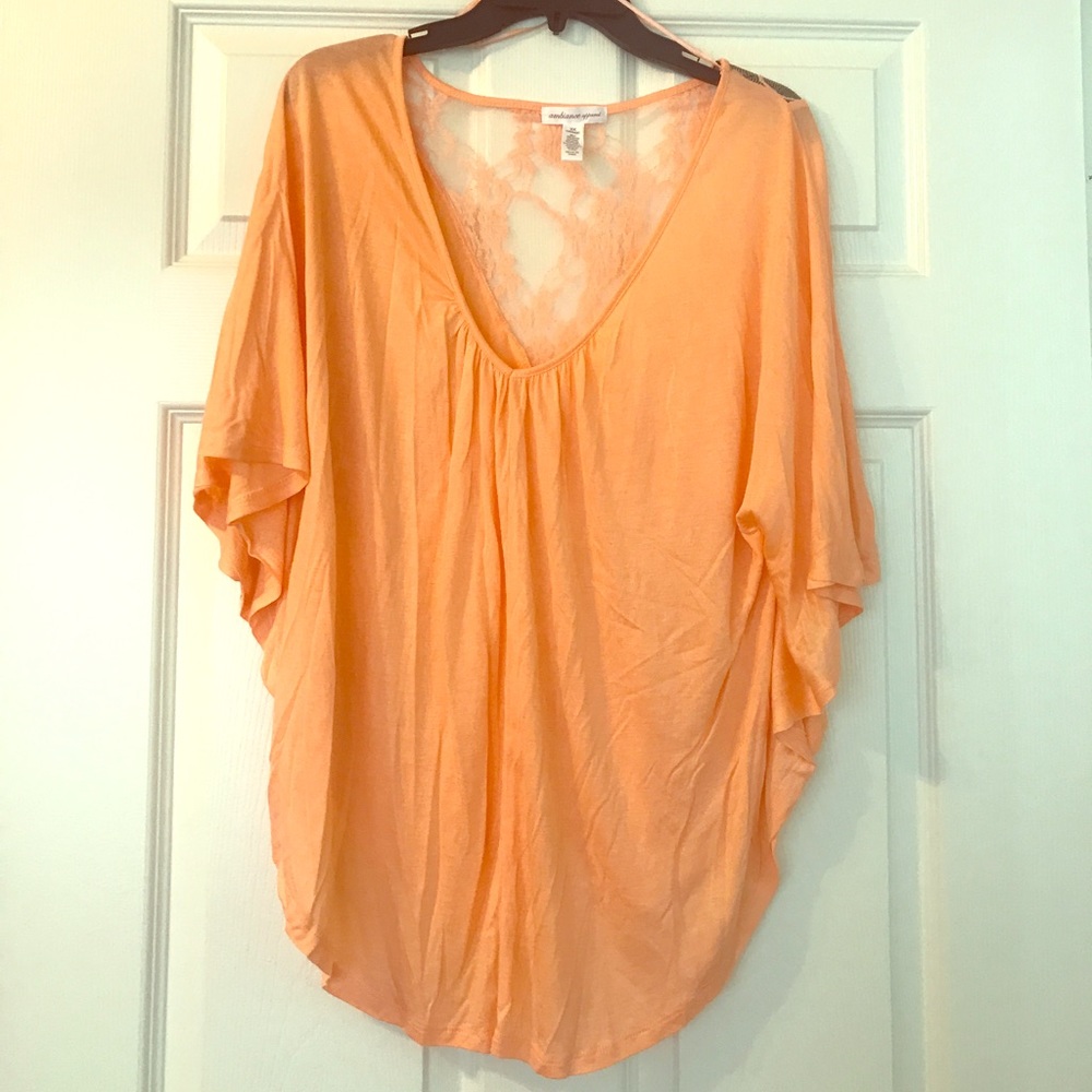 Pastel orange flowy top with lace back.