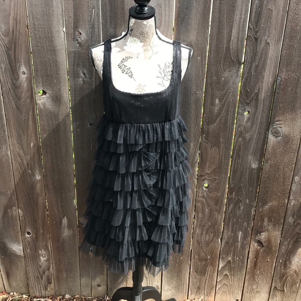 Sleeveless black dress with ruffled tulle