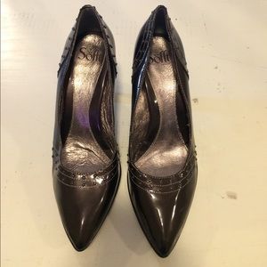 Dark silver high heeled shoes.