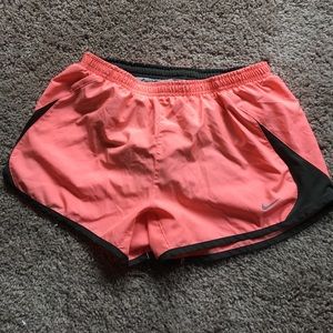 Coral Nike running shorts