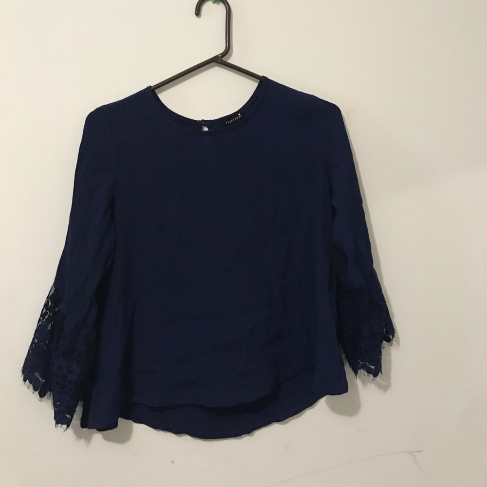 Dark blue top with lace sleeves near/at the wrist