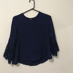 Dark blue top with lace sleeves near/at the wrist