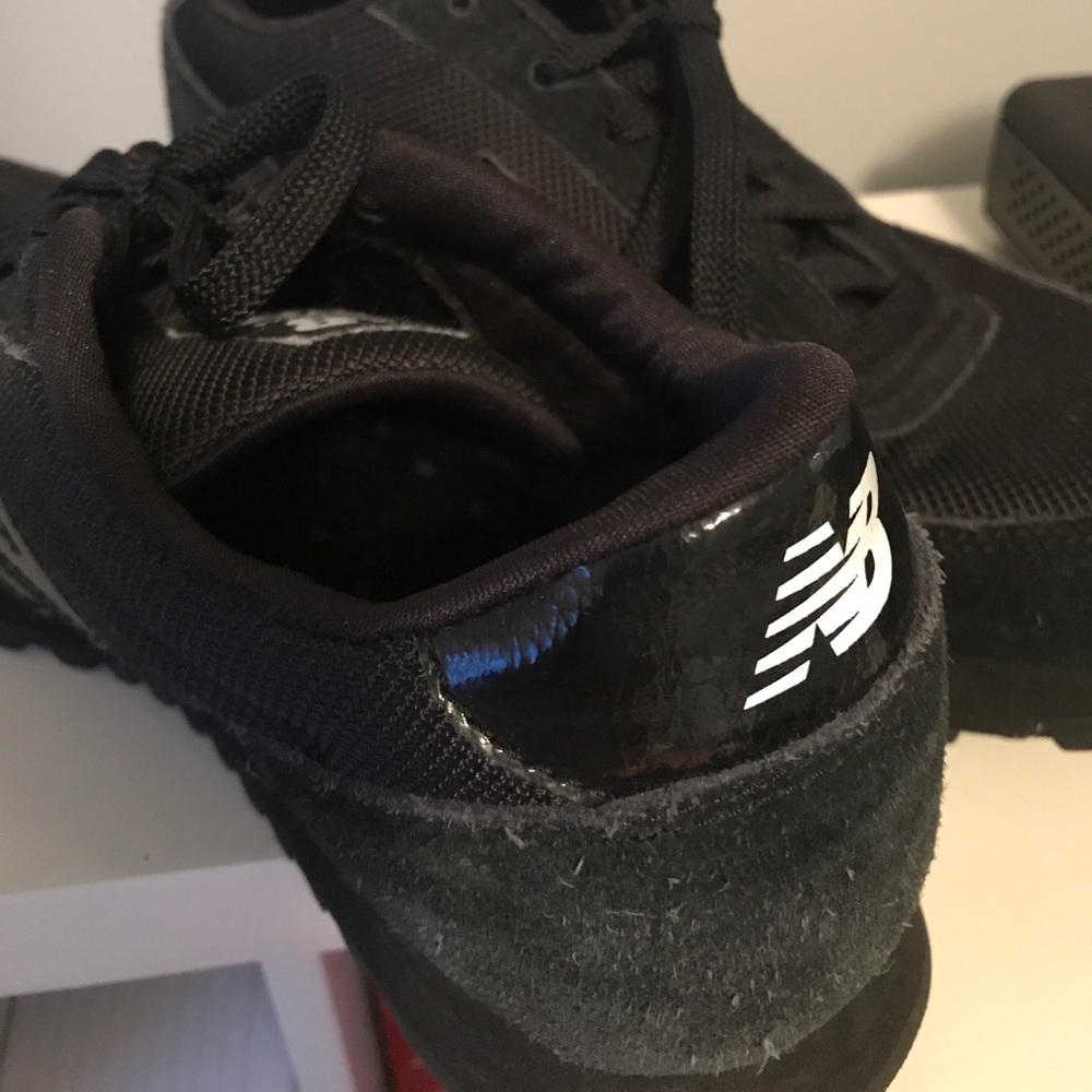 All black New Balance sneakers