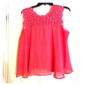Alya, coral colored top with lace detail.