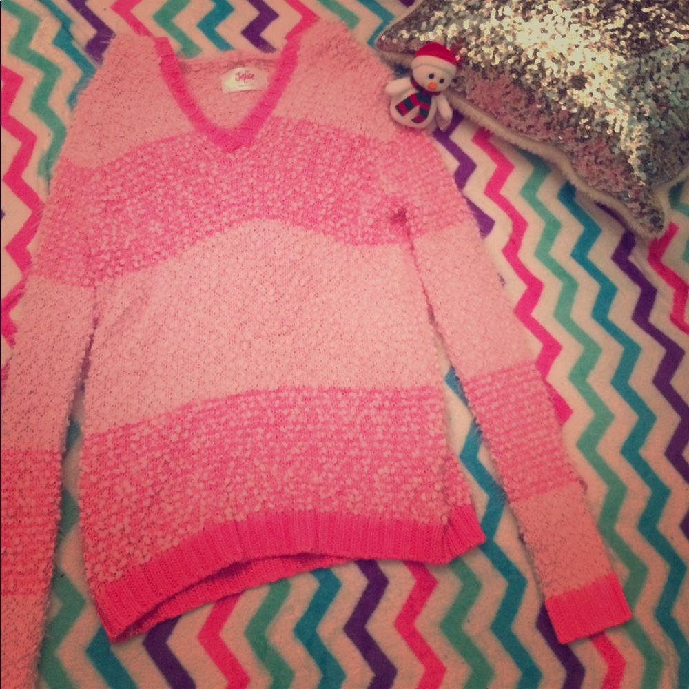 This is a light pink and dark pink sweater.